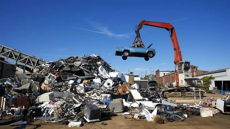 scrapp car being lifted by material handler