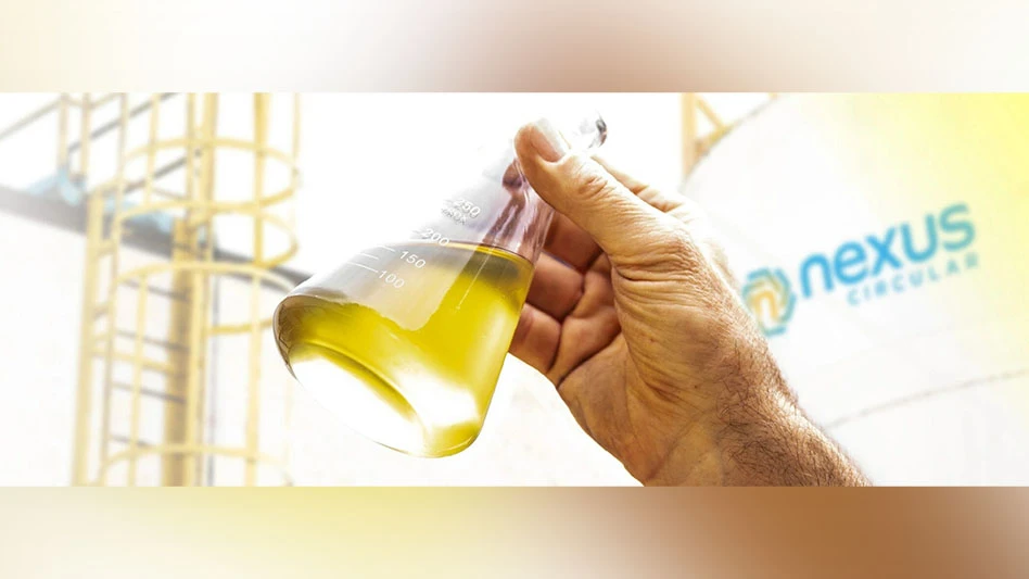 A hand holds up a container of liquid, symbolizing Nexus Circular's commitment to advanced recycling.