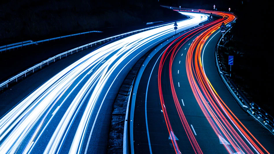 vehicle light streaks on highway at night