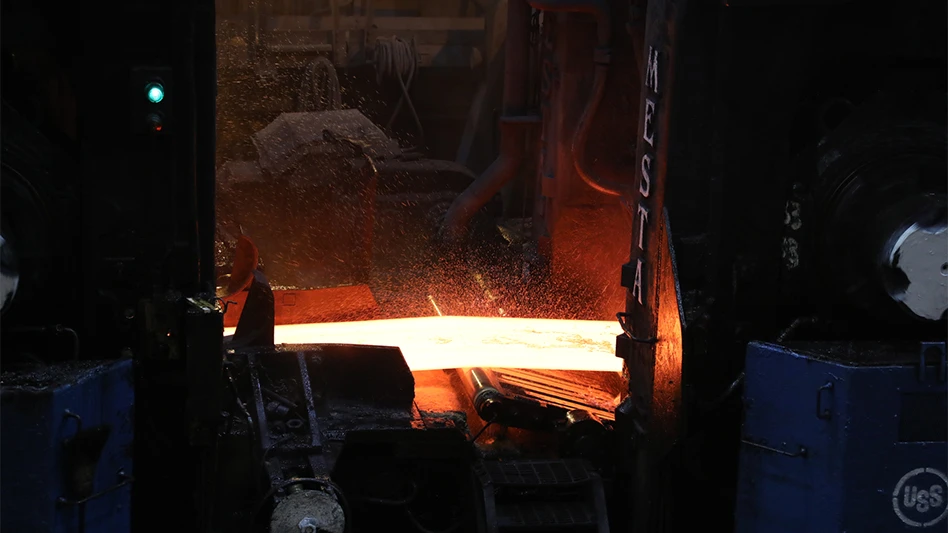 A slab of steel moves through the hot strip mill. Slabs start this process several inches thick and are rolled into sheet steel that is fractions of an inch thick.