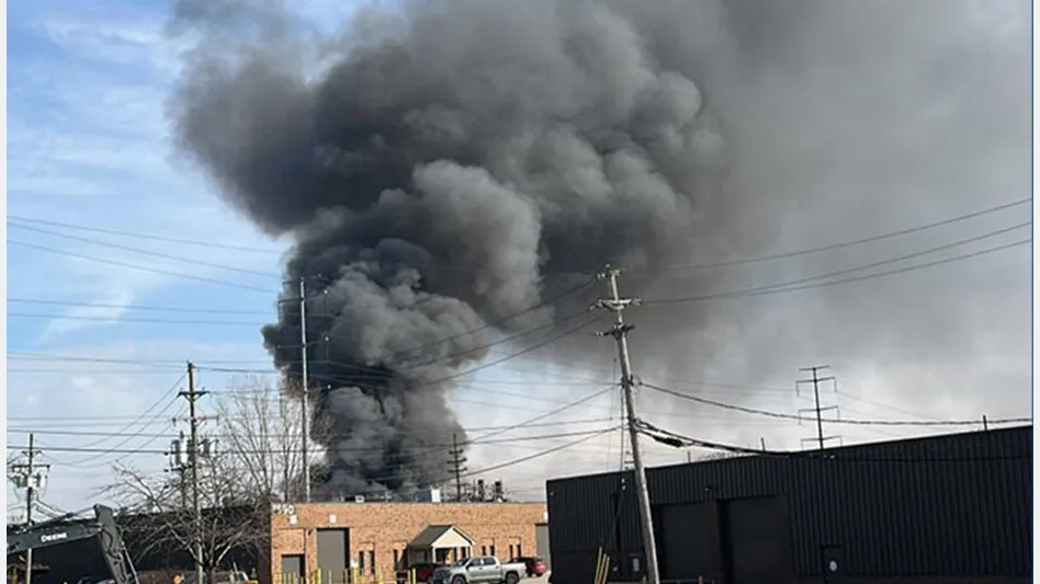 a plume of black smoke above an industrial building