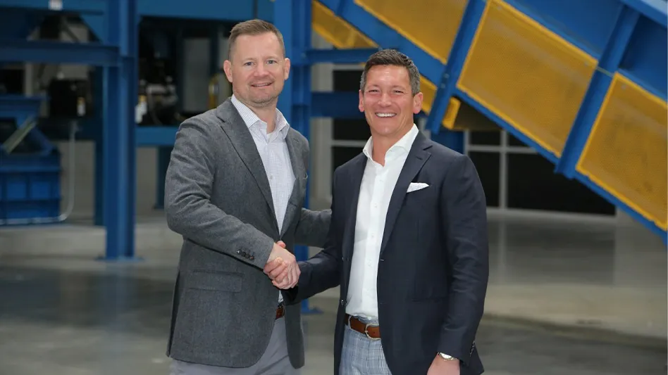 Procurri Global President of ITAD and Lifecycle Services Evrim Eravci (right) shakes hands with Igneo Technologies Chief Commercial Officer Brian Diesselhorst (left) during the Ribbon cutting ceremony of a Las Vegas recycling facility..