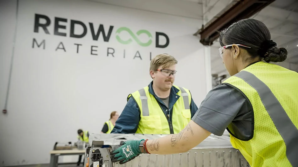 two people work on an EV battery at Redwood Materials