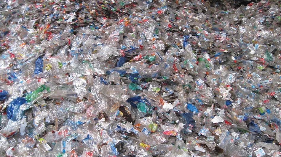 A large pile of flattened plastic bottles.