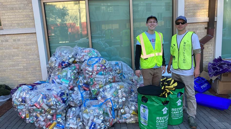 CMI Vice President of Sustainability Scott Breen and Grounds Krewe Founder Brett Davis stand in front of bagged cans.