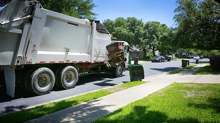 recycling truck picks up curbside bin