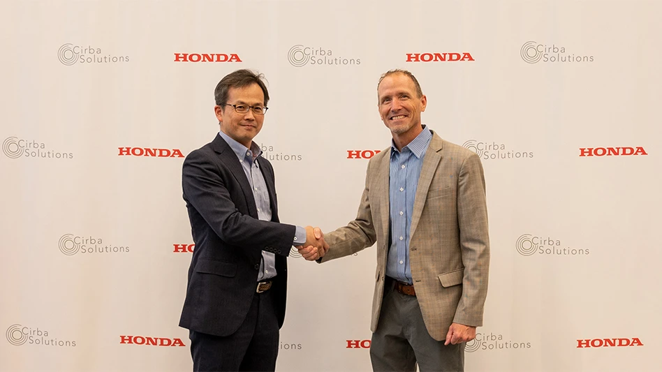 Wataru Taga, general manager of the resource circulation planning division at Honda and David Klanecky, president & CEO at Cirba Solutions, shake hands after signing a memorandum of understanding between the two companies.