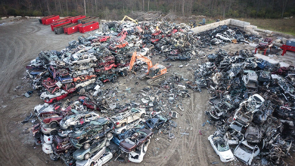 a scrap yard with stacked crushed cars