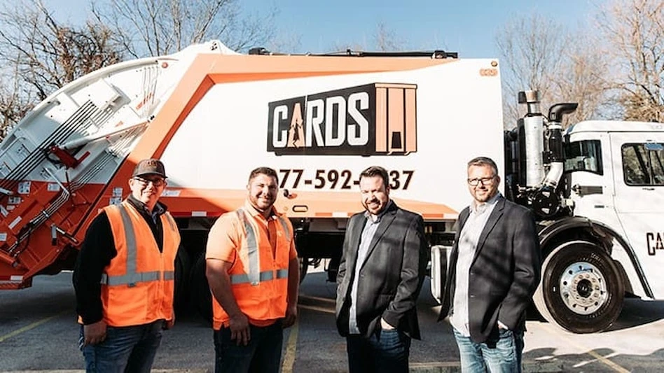 Cards employees pose in front of Cards waste truck