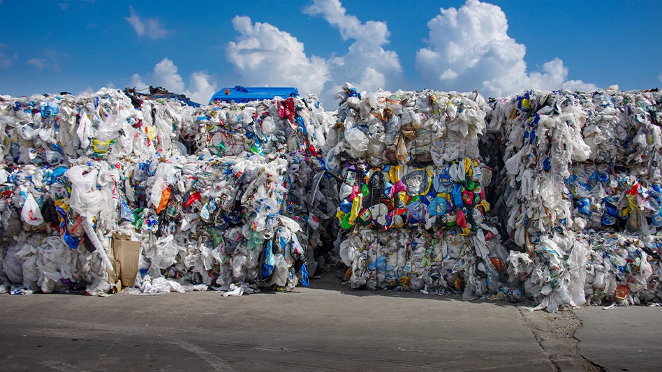 Bales of residential film plastics sitting outdoors.