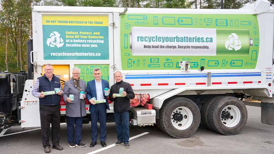 From left to right, Peterborough Deputy Mayor Gary Baldwin; Peterborough Deputy Mayor Joy Lachica, Call2Recycle Canada President Joe Zenobio and; Peterborough Councilor Kevin Duguay, pose in front of a city refuse truck adorned with Call2Recycle battery recycling information.