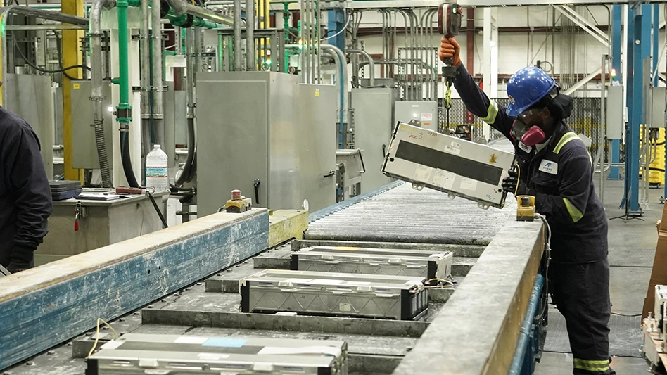 An Ascend Elements team member works with lithium-ion batteries on a conveyor line at an Ascend plant.