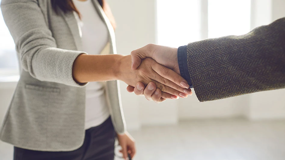 Two businesspeople shake hands.