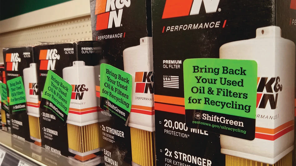 Oil filters on the shelf of a Renton, Washington, auto parts store, bearing Shift Green program stickers.