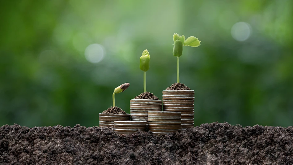 stacked coins with plants sprouting from the top