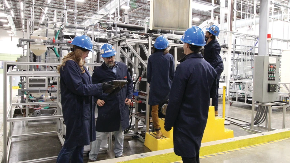 Electra's Melissa Mansour, Faxson Cockrell, Colleen Wallace, Ben Whitman and Michael Street inspect a plate of iron from Electra's low-temperature iron electrowinning cell at its pilot plant in Boulder, Colorado.