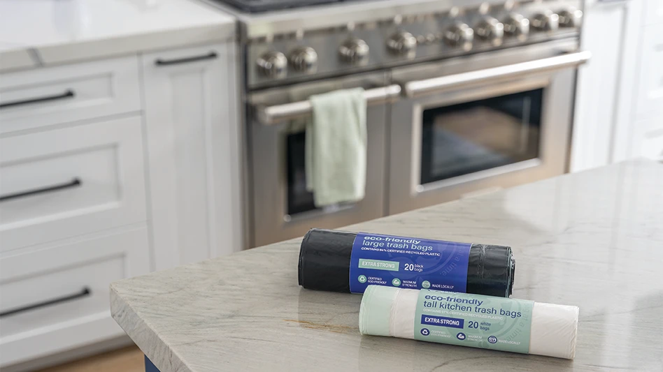 Revolution's new Dailygood Bags, in white and black color formats, sitting atop a marble kitchen counter.