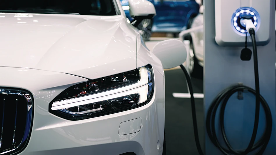 An electric vehicle hooked up to a charger.