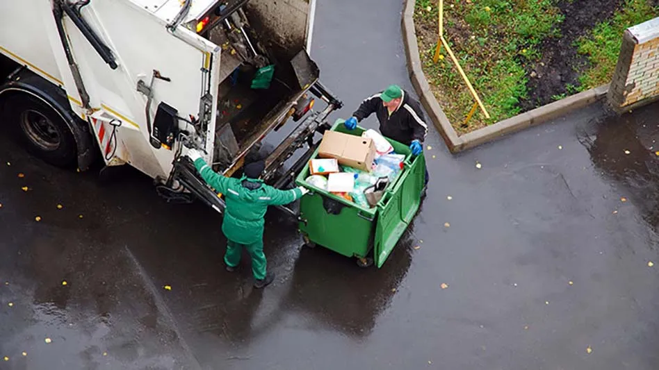 recycling hauler loading a truck with recyclables