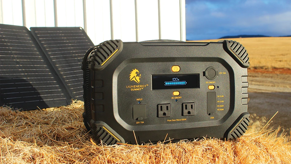 Lion Energy's Summit solar generator, stationed in front of two panels and a white structure on a farm.