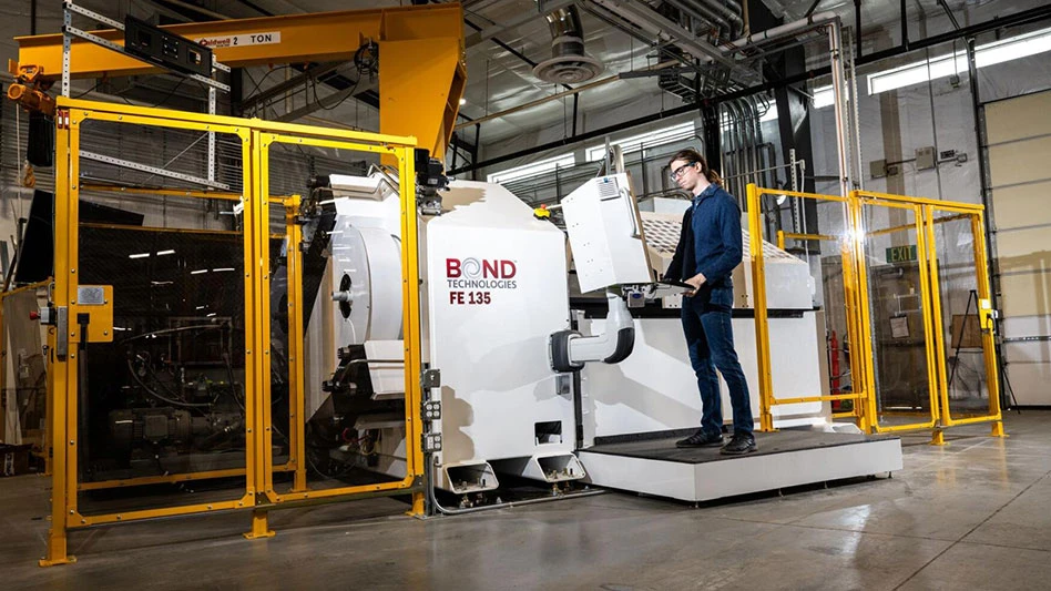 A man stand in front of ShAPE 2 at the PNNL lab