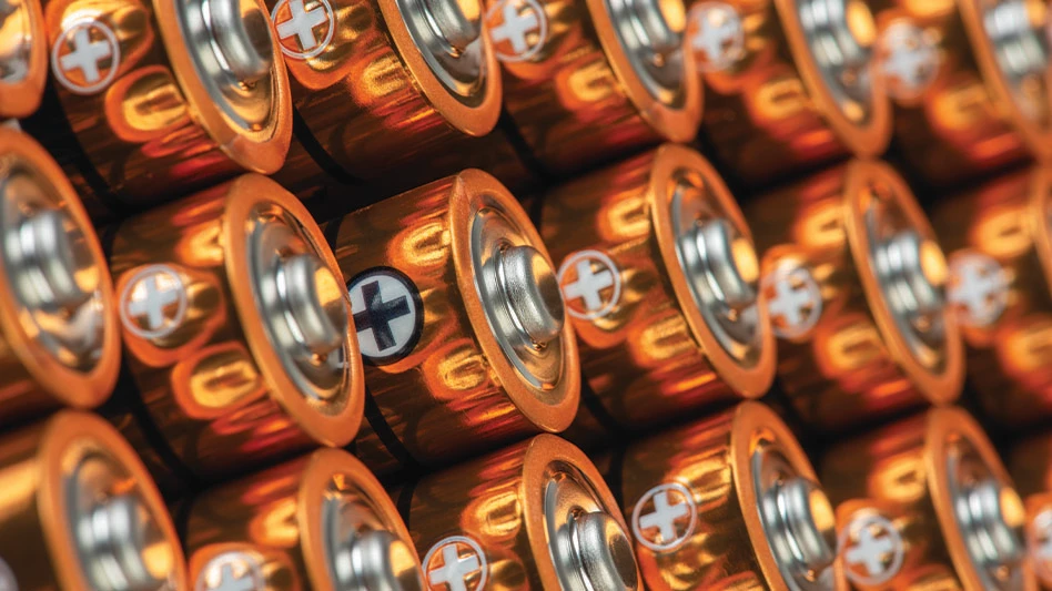 A closeup of stacks of alkaline batteries with gold tops.