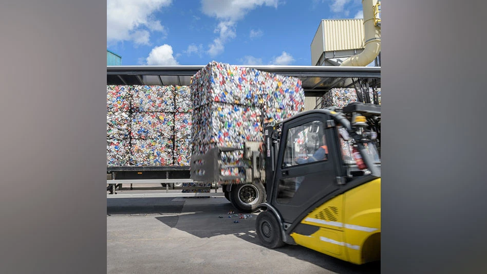 a forklift carries ubc bales