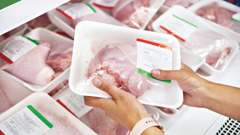 A pair of hands hold a Recycleware reduced-density polypropylene meat tray developed by Pactiv Evergreen.