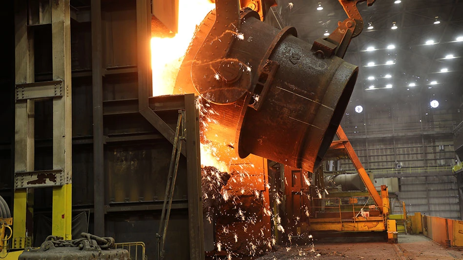 A ladle of molten iron is poured into a Basic Oxygen Process furnace where it will be transformed into liquid steel