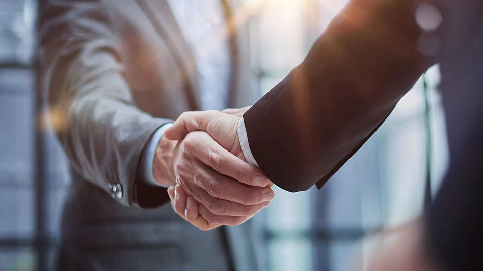 Two diverse professional business men executive leaders shaking hands at office meeting