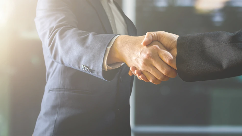 Two businessmen shake hands.