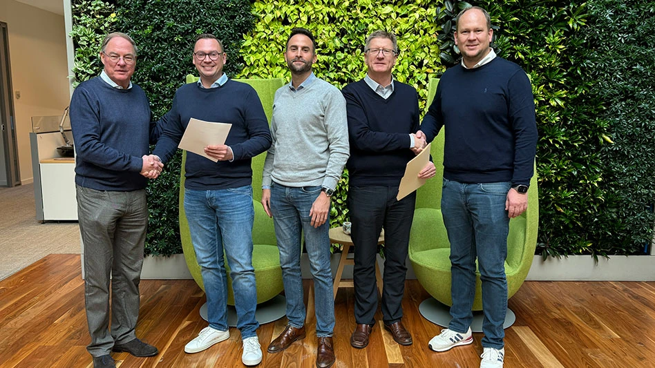 five white men stand infront of a live wall