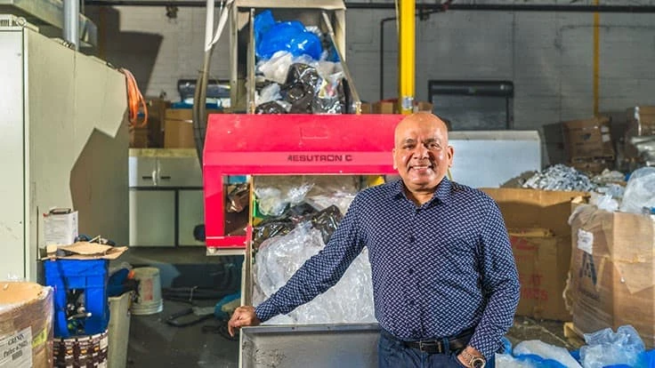 sunil bagaria in front of conveyor loaded with plastic film