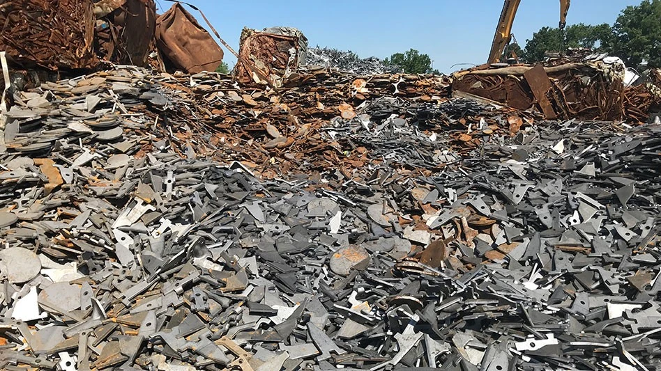 pile of ferrous scrap with material handler in background