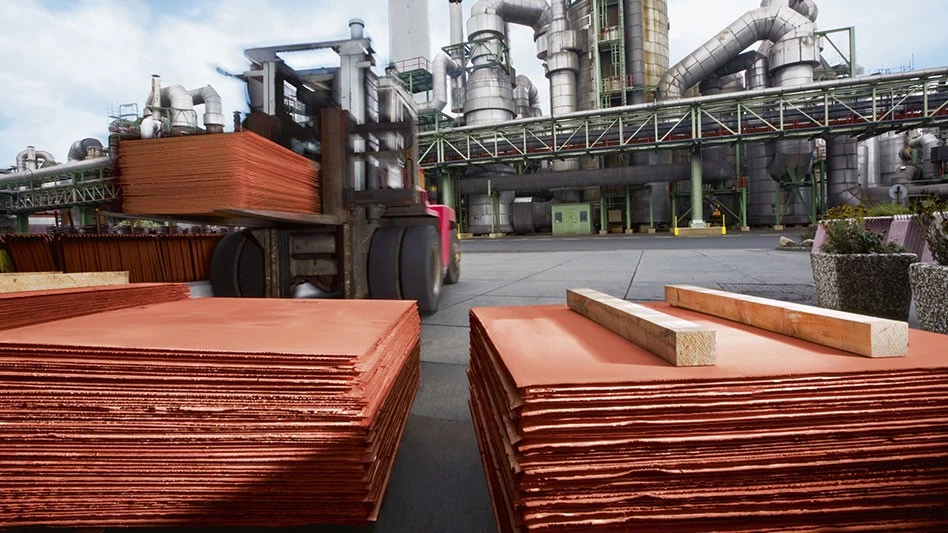 copper cathodes in front of a forklift carrying more copper cathode