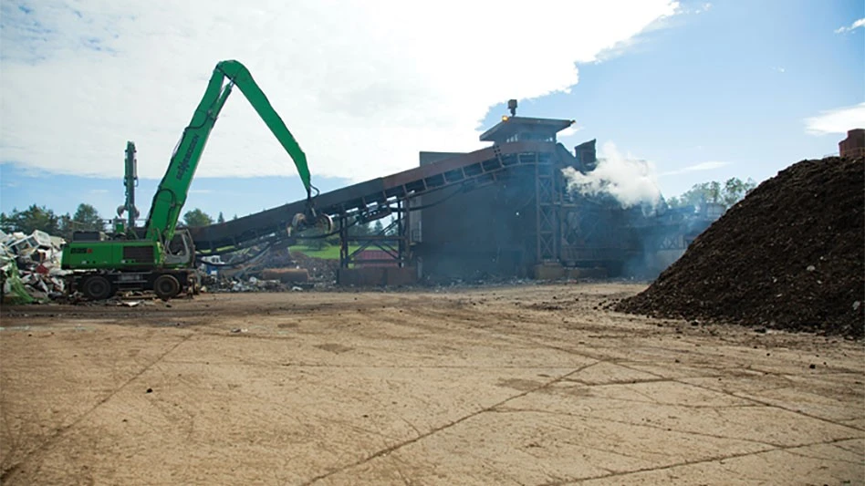 a Sennebogen loads the conveyor belt leading to an auto shredder